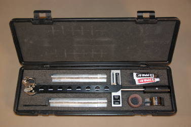 Adhesion tester in carrying case with dollies and 90 degree vertical head