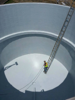 Man standing inside of an open digester tank after restoration