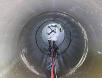 Man inside a concrete culvert pipe