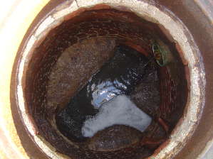 Bird's eye view of a deteriorated brick manhole before rehabilitation