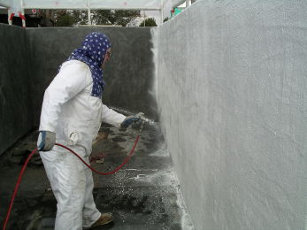 Spraying DS-5 100% Solids Epoxy Coating onto the uncured mortar