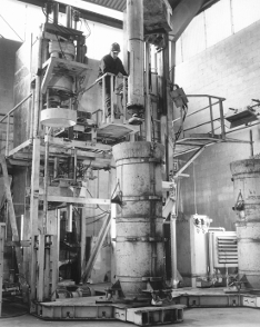 A worker uses a spincasting device to spin coal tar epoxy inside an uncured, unreinforced concrete pipe