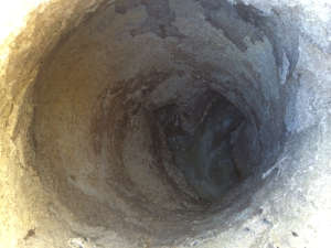 Bird's eye view of severely corroded concrete manhole
